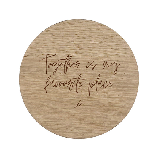 Round wooden coaster with text 'Together is my favourite place' on a white background