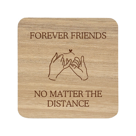 Wooden coaster with text 'Forever Friends No Matter The Distance' on a white background