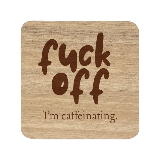 Wooden coaster with text 'fuck off I'm caffeinating' on a white background