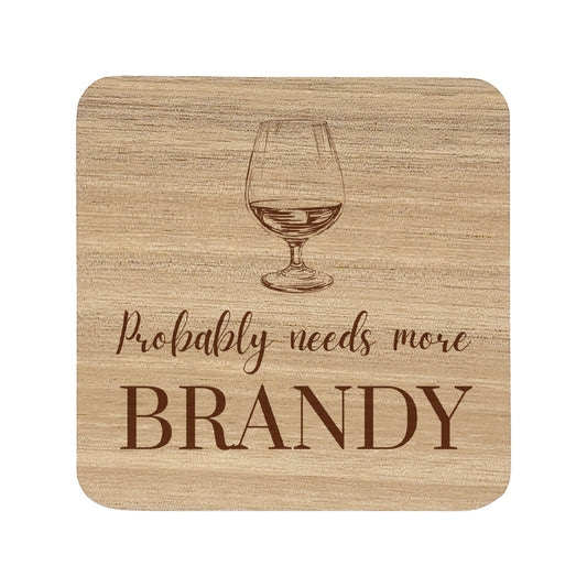 Square wooden coaster with "probably needs more brandy" text and brandy glass illustration