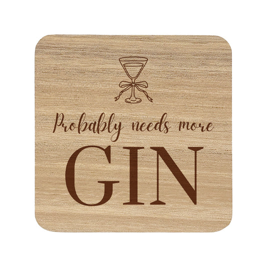 wooden coaster featuring the funny quote "Probably needs more gin" in crisp lettering with a gin glass illustration.