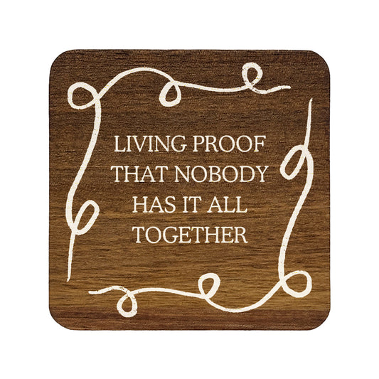 Square wooden coaster with quote 'Living proof that nobody has it all together' in white lettering.