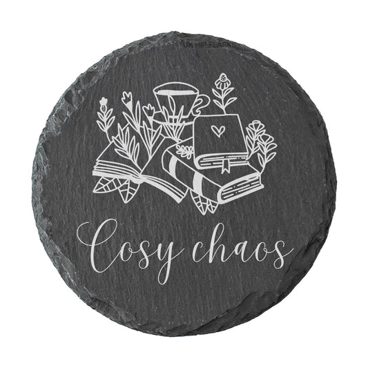 Round slate coaster with the quote "Cosy chaos" in white text.