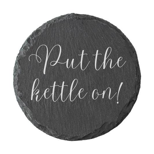 Round slate coaster with 'Put the kettle on!' text on a white background