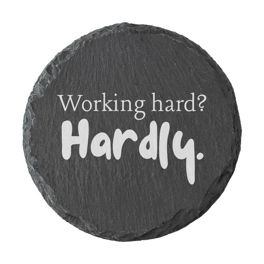 Round slate coaster with motivational quote 'Working hard? Hardly.' on a white background