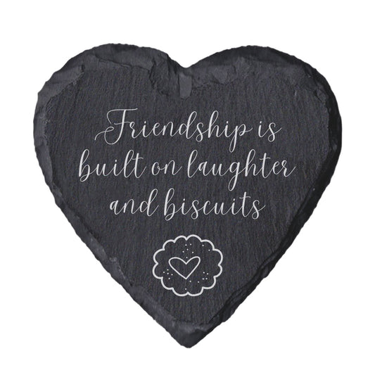 Heart-shaped slate coaster with 'Friendship is built on laughter and biscuits' text
