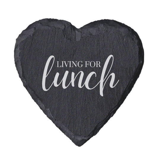 Heart-shaped slate coaster with 'Living for lunch' text on a white background