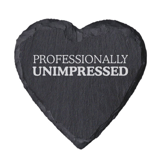 Heart-shaped slate coaster with 'PROFESSIONALLY UNIMPRESSED' text on a white background