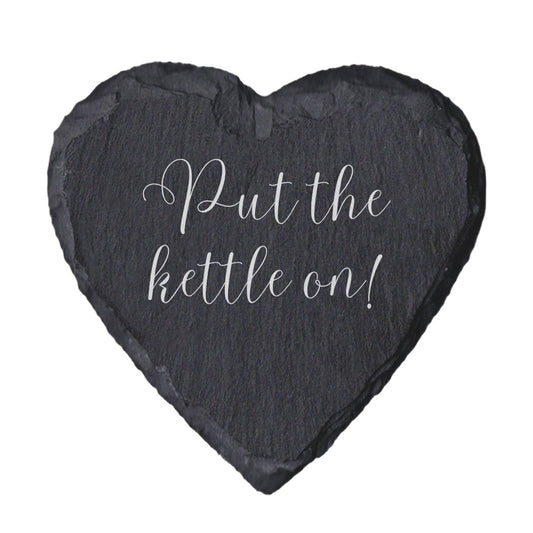 Heart-shaped slate coaster with 'Put the kettle on!' text on a white background