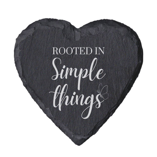 Heart-shaped slate coaster with 'Rooted in Simple Things' text on a white background