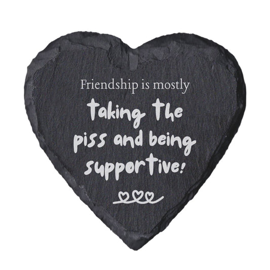 Heart-shaped slate coaster with humorous friendship quote on a white background