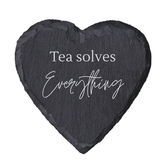 Heart-shaped slate coaster with 'Tea solves Everything' text on a white background