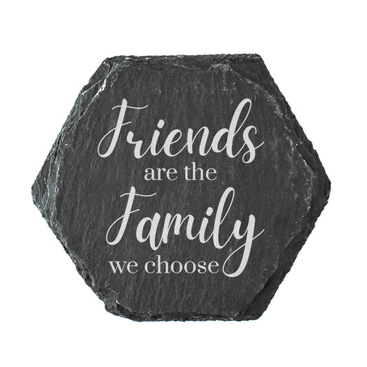 Hexagonal slate coaster with white text 'Friends are the family we choose' on a white background