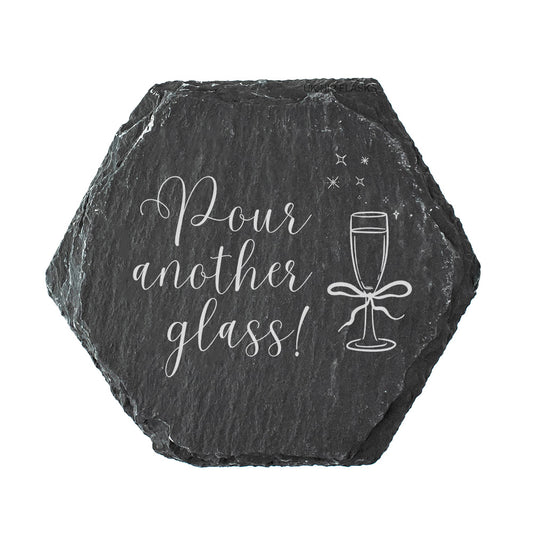Hexagonal slate coaster with 'Pour another glass!' text and prosecco glass illustration on a white background