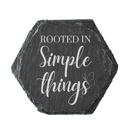 Hexagonal slate coaster with 'Rooted in Simple Things' text on a white background