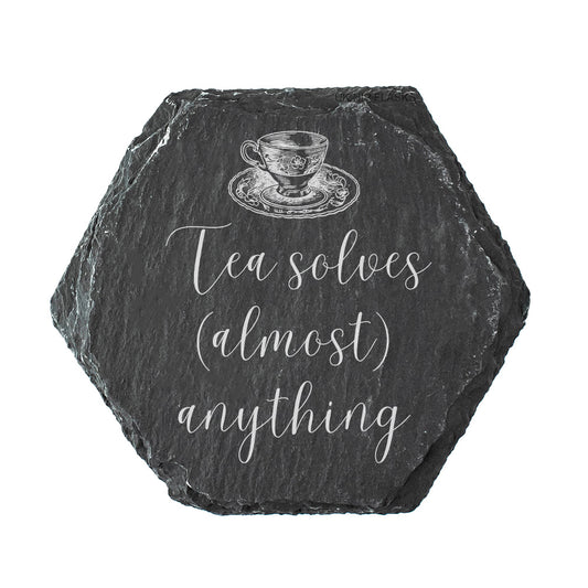 Hexagonal slate coaster with a tea cup illustration and text 'Tea solves (almost) anything' on a white background.