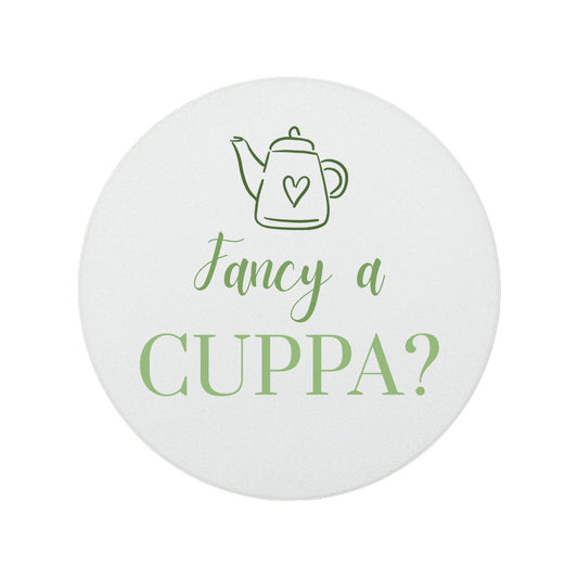Round ceramic coaster featuring the cheerful quote "Fancy a cuppa?" in crisp green lettering.