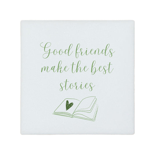 Square ceramic coaster featuring the friendship quote "Good friends make the best stories" in crisp green lettering with a book illustration underneath.