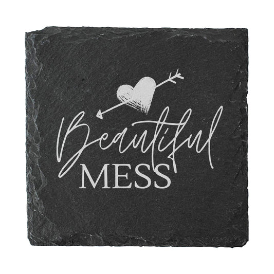 Black slate coaster with 'Beautiful Mess' text and heart design on a white background