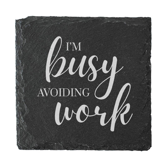 Slate coaster with 'I'm busy avoiding work' text on a white background