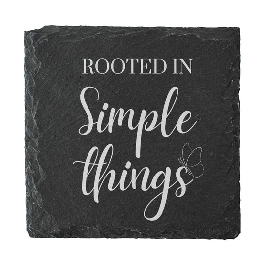 Black slate coaster with 'Rooted in Simple Things' text and butterfly design on a white background
