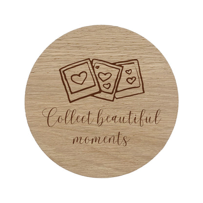 Round wooden coaster with photo design and text 'Collect beautiful moments' on a white background