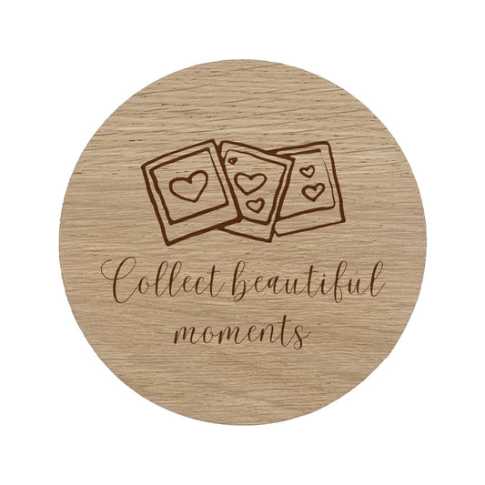Round wooden coaster with photo design and text 'Collect beautiful moments' on a white background