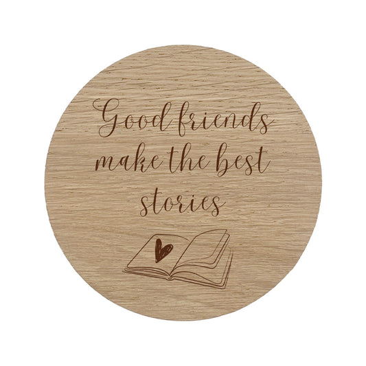 Wooden coaster with 'Good friends make the best stories' text and a book illustration.