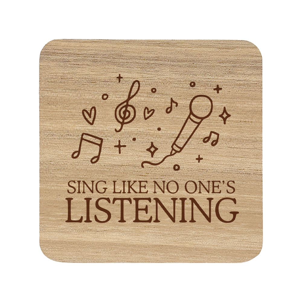 Wooden coaster with 'Sing Like No One's Listening' text and microphone and music note illustration.
