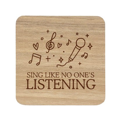 Wooden coaster with 'Sing Like No One's Listening' text and microphone and music note illustration.