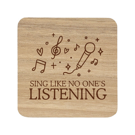 Wooden coaster with 'Sing Like No One's Listening' text and microphone and music note illustration.