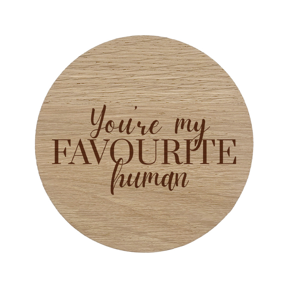 Round wooden coaster with 'You're my favourite human' text on a white background