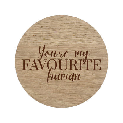 Round wooden coaster with 'You're my favourite human' text on a white background