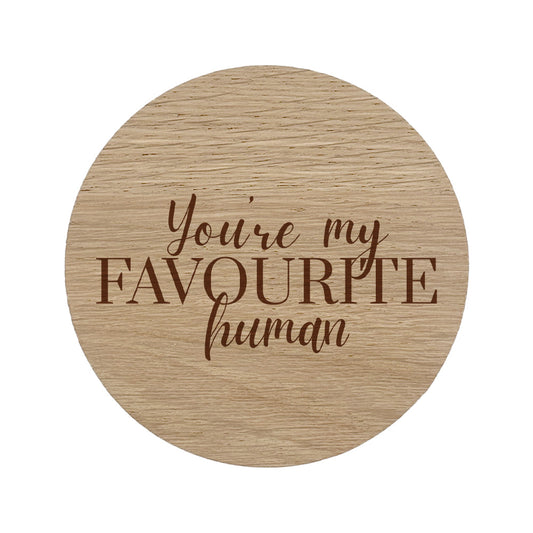 Round wooden coaster with 'You're my favourite human' text on a white background