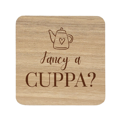 Wooden coaster with teapot illustration and 'Fancy a Cuppa?' text on a white background