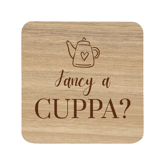 Wooden coaster with teapot illustration and 'Fancy a Cuppa?' text on a white background