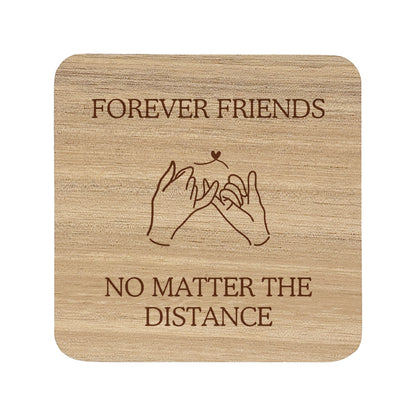 Wooden coaster with text 'Forever Friends No Matter The Distance' on a white background