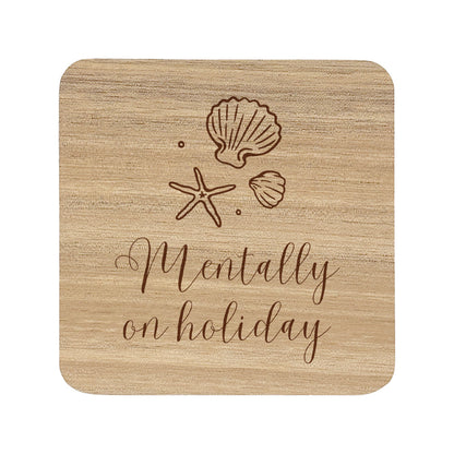 Wooden coaster with shell and starfish designs and 'Mentally on holiday' text.
