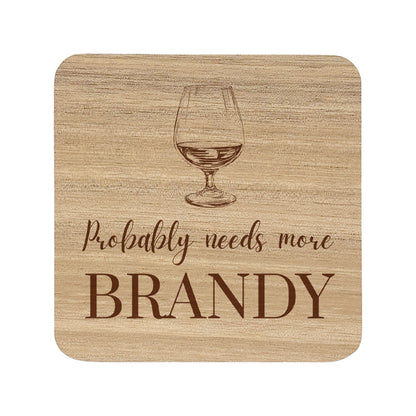 Square wooden coaster with "probably needs more brandy" text and brandy glass illustration