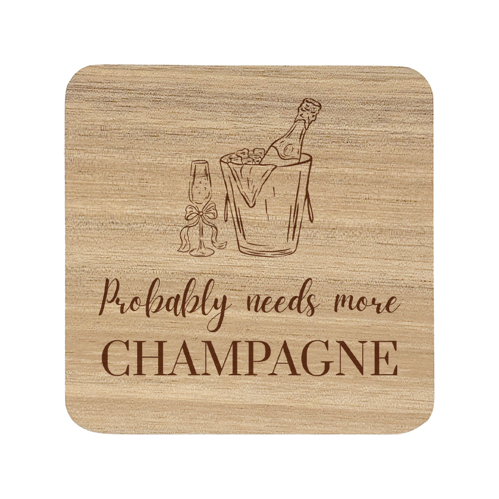Square wooden coaster featuring the funny quote "Probably needs more champagne" in crisp lettering with a champagne bottle and glass illustration