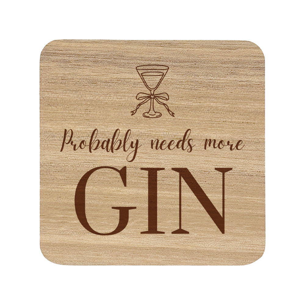  wooden coaster featuring the funny quote "Probably needs more gin" in crisp lettering with a gin glass illustration. 