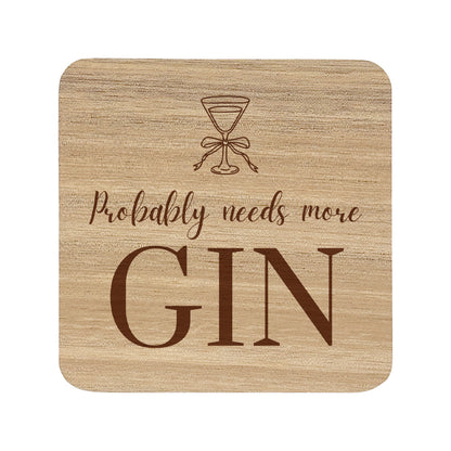  wooden coaster featuring the funny quote "Probably needs more gin" in crisp lettering with a gin glass illustration. 