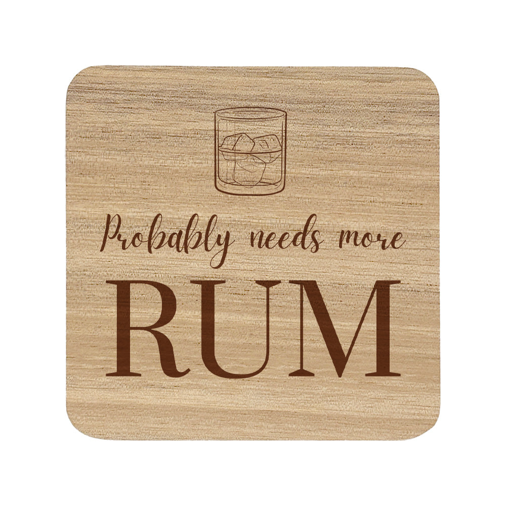 Square wooden coaster featuring the funny quote "Probably needs more rum" in crisp lettering with a rum glass illustration.