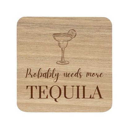 Square wooden coaster featuring the funny quote "Probably needs more tequila" in crisp lettering with a tequila cocktail illustration.