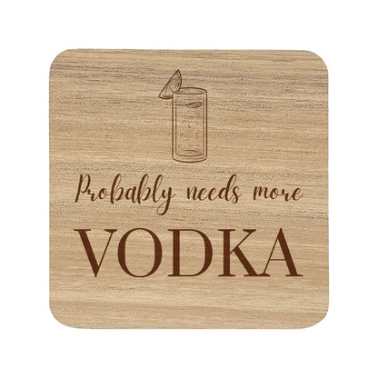 Square wooden coaster with 'Probably needs more VODKA' text and vodka tonic illustration.
