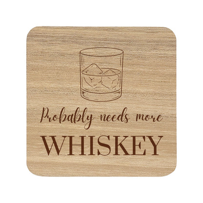 Square wooden coaster with 'Probably needs more whiskey' text and whiskey glass illustration.