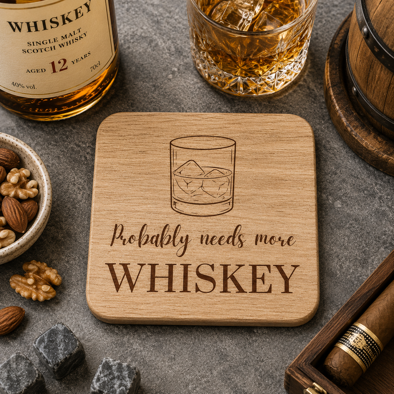 Square wooden coaster with 'Probably needs more whiskey' text and whiskey glass illustration on a bar with whiskey bottle and barrel.