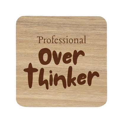 Square wooden coaster with 'professional over thinker' text