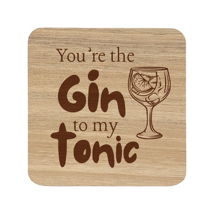 Square wooden coaster with the quote 'You're the gin to my tonic' and gin glass illustrations 