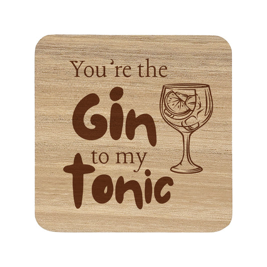 Square wooden coaster with the quote 'You're the gin to my tonic' and gin glass illustrations 